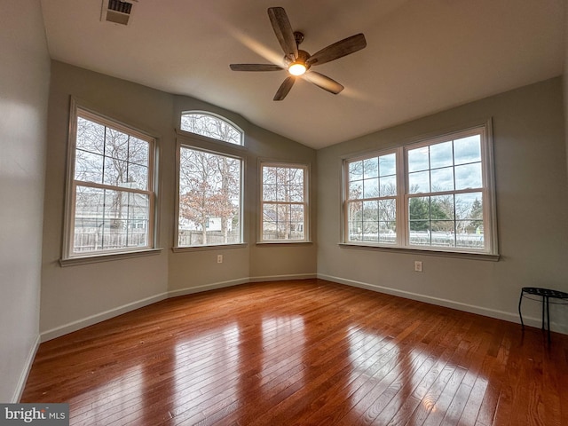 spare room with ceiling fan, vaulted ceiling, and light wood-type flooring