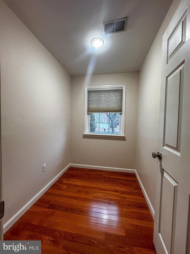 unfurnished room with dark hardwood / wood-style flooring