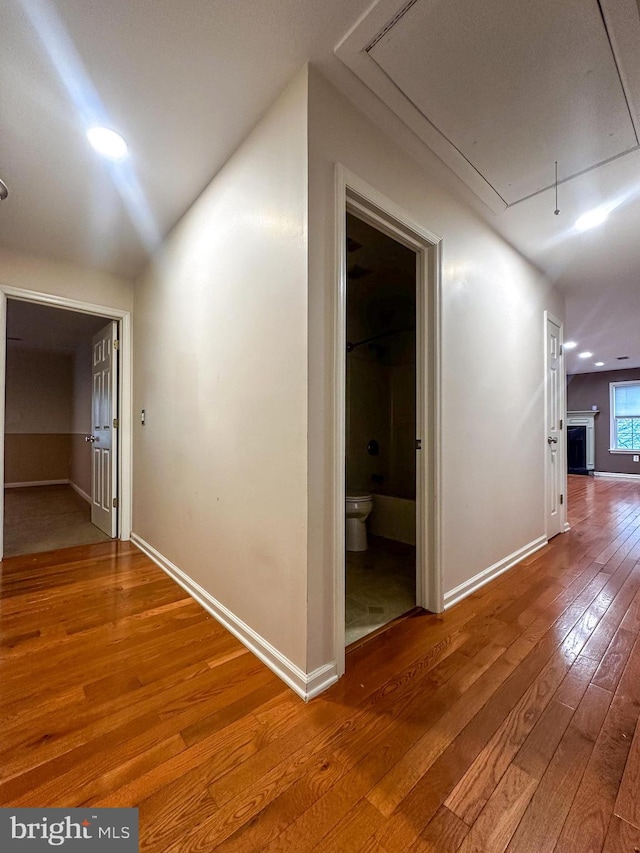 hall with hardwood / wood-style floors