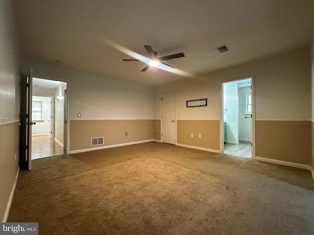 unfurnished bedroom featuring ceiling fan, carpet flooring, and ensuite bath