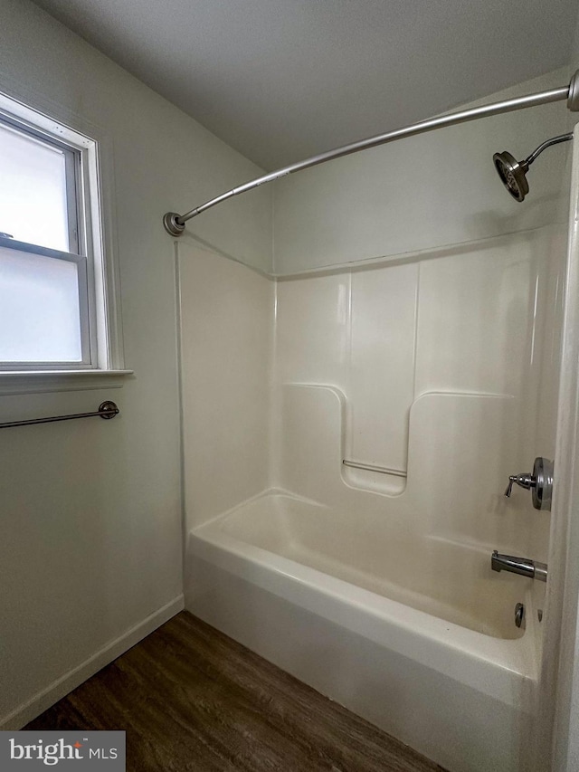 bathroom featuring hardwood / wood-style flooring and tub / shower combination