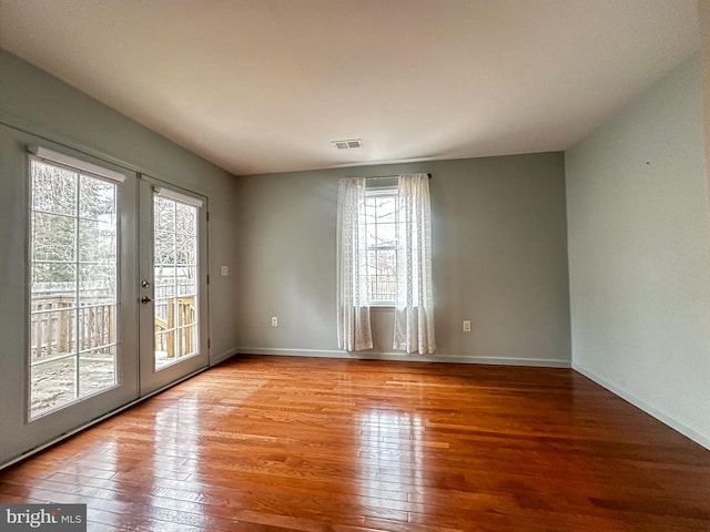 unfurnished room with light hardwood / wood-style flooring and french doors