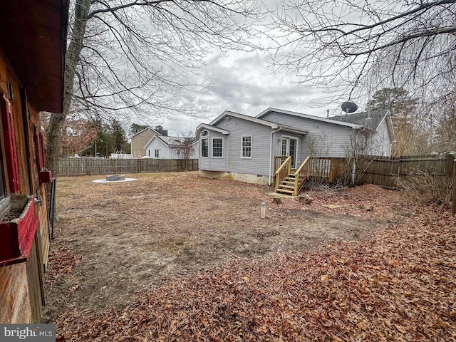 rear view of property with an outdoor fire pit