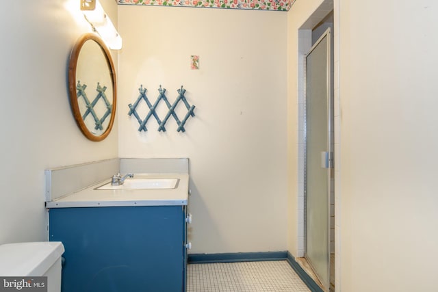 bathroom with vanity, toilet, and an enclosed shower