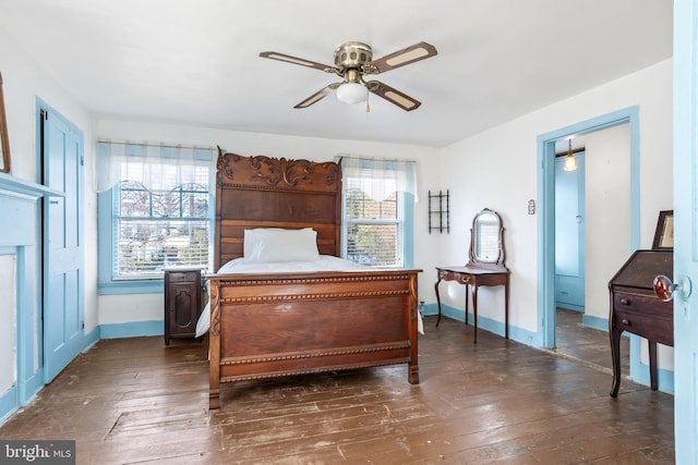 bedroom with dark hardwood / wood-style flooring and ceiling fan