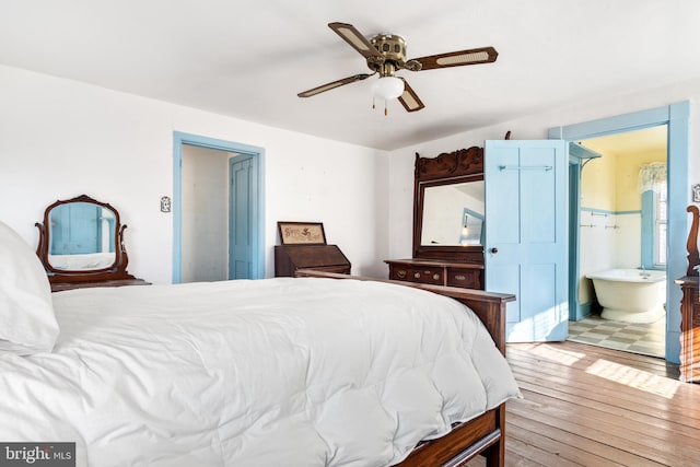 bedroom with hardwood / wood-style flooring, ceiling fan, and connected bathroom