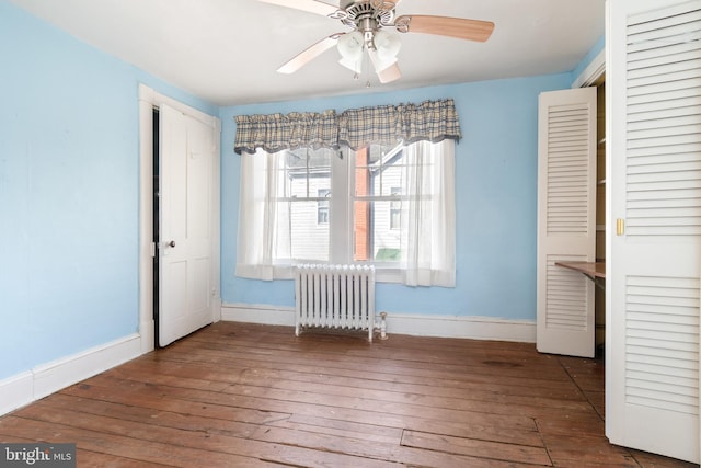 interior space with radiator, wood-type flooring, and ceiling fan