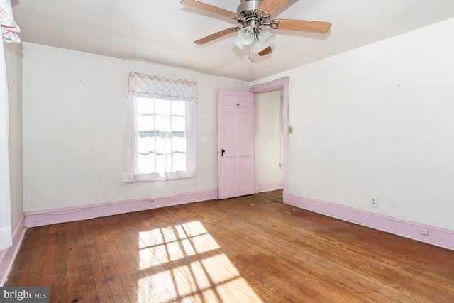 empty room featuring hardwood / wood-style flooring and ceiling fan