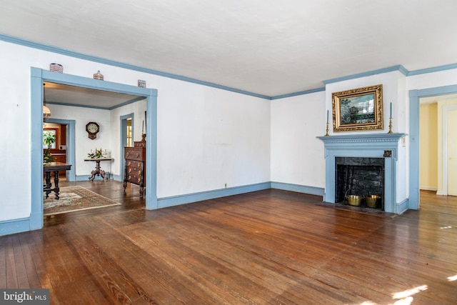 unfurnished living room featuring ornamental molding, a high end fireplace, and dark hardwood / wood-style flooring