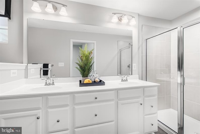 bathroom featuring vanity and a shower with door