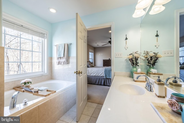 bathroom featuring vanity, tiled tub, and tile patterned floors