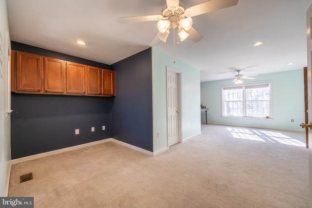 carpeted spare room with ceiling fan