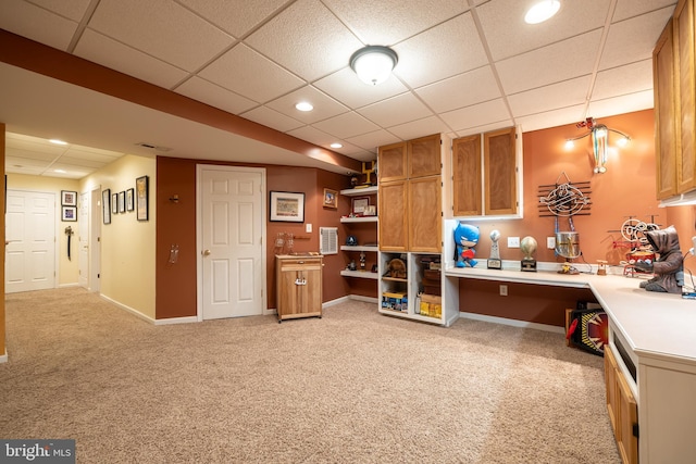 interior space featuring light colored carpet and a drop ceiling