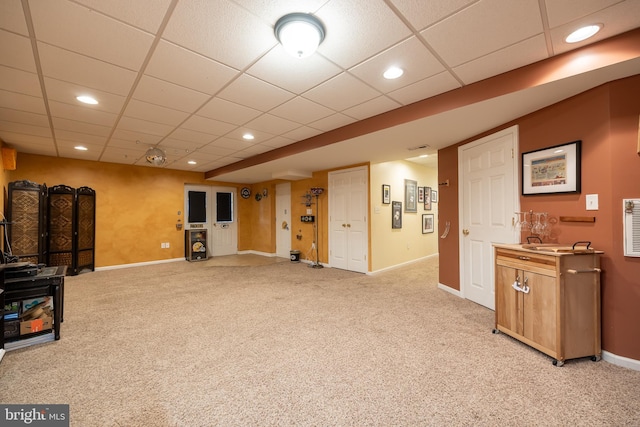 living room featuring light colored carpet and a paneled ceiling