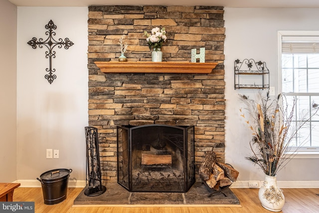 details with hardwood / wood-style flooring and a fireplace