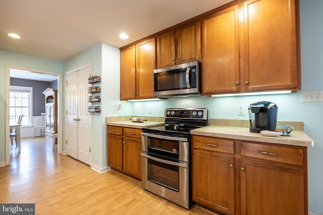 kitchen with stainless steel appliances and light wood-type flooring