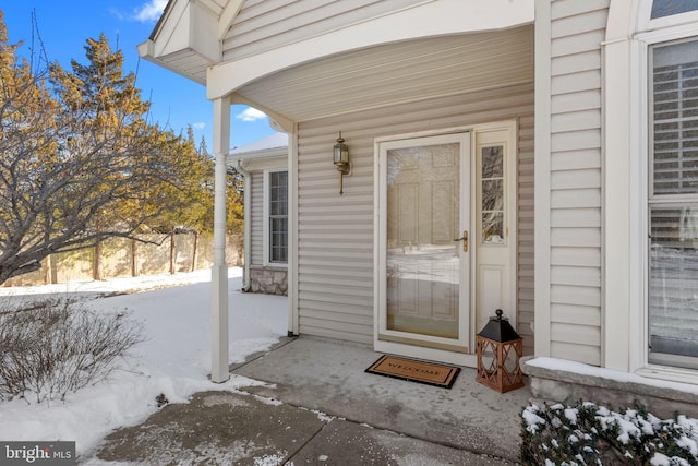 view of snow covered property entrance