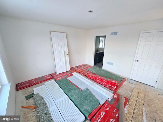 interior space featuring visible vents and connected bathroom