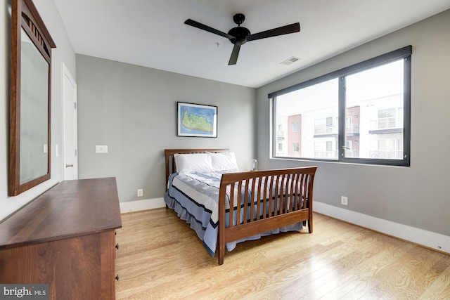 bedroom with ceiling fan and light wood-type flooring