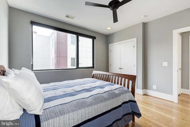 bedroom with ceiling fan, a closet, and light wood-type flooring