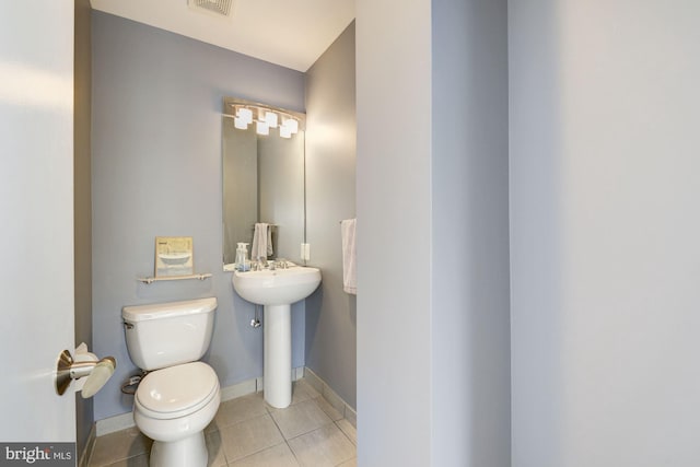 bathroom with tile patterned floors and toilet