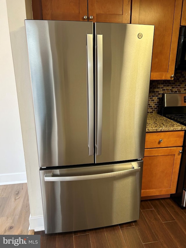 details featuring tasteful backsplash, stone countertops, and stainless steel appliances