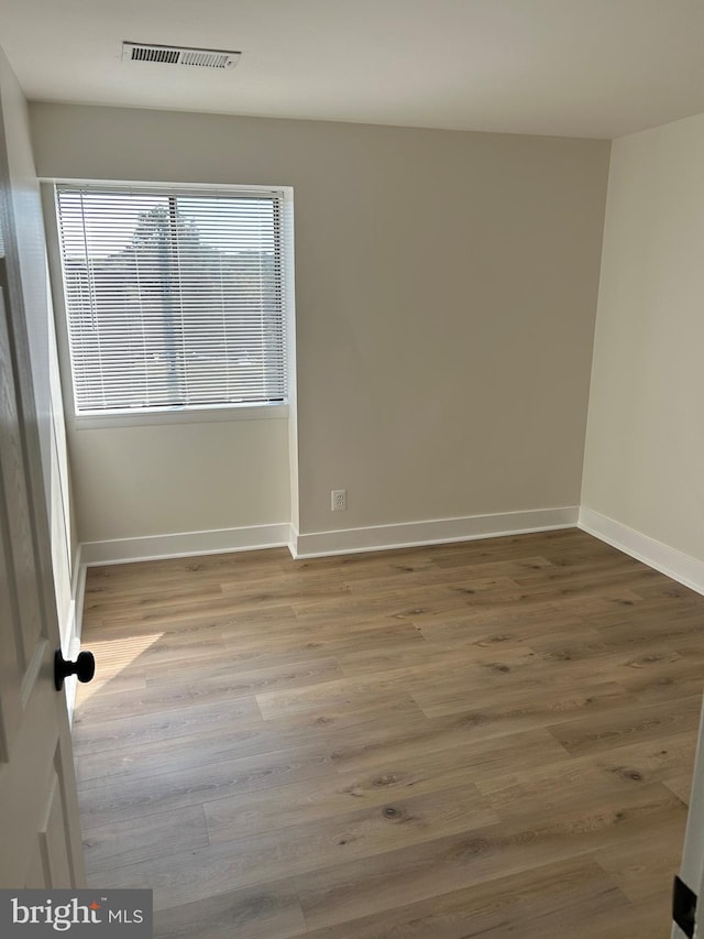 spare room with light wood-type flooring