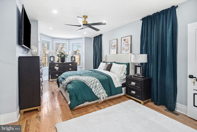 bedroom with ceiling fan and hardwood / wood-style floors