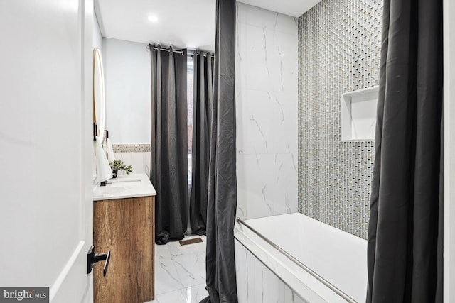 bathroom featuring tile walls, vanity, and a shower with curtain