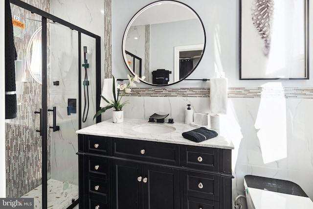 bathroom with vanity, toilet, tile walls, and a shower with door