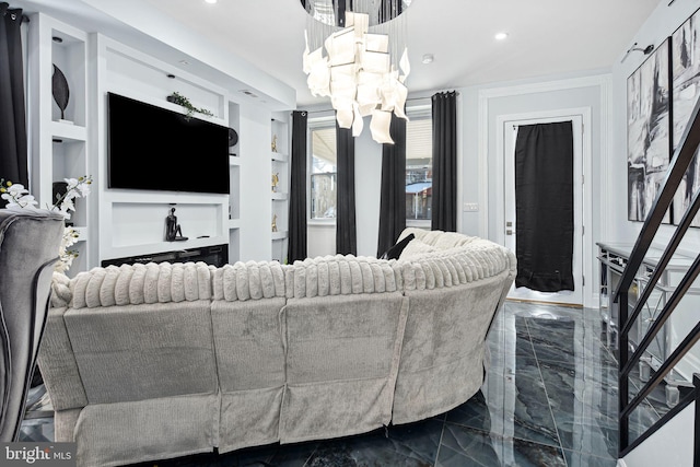 living room featuring built in shelves and an inviting chandelier