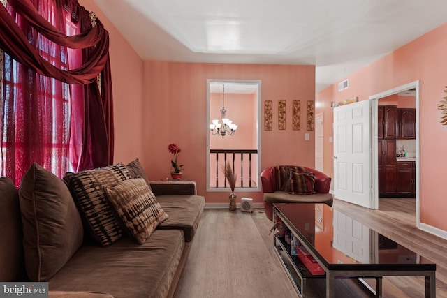 living room featuring a chandelier and hardwood / wood-style flooring