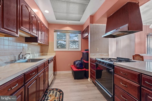 kitchen featuring light hardwood / wood-style floors, sink, black gas stove, island range hood, and stainless steel dishwasher