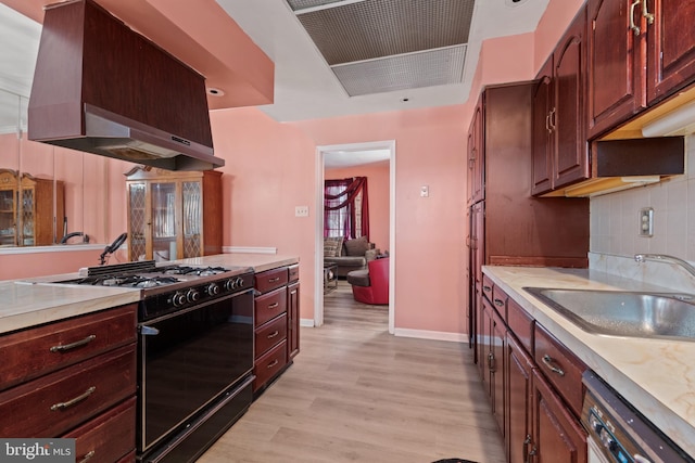 kitchen featuring dishwasher, light hardwood / wood-style floors, island exhaust hood, sink, and black gas range oven