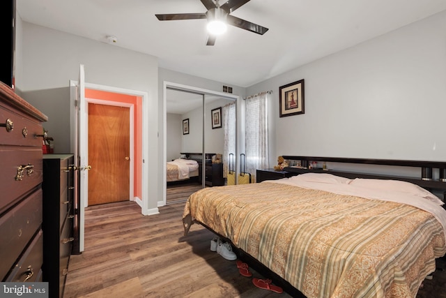 bedroom with ceiling fan, a closet, and hardwood / wood-style floors