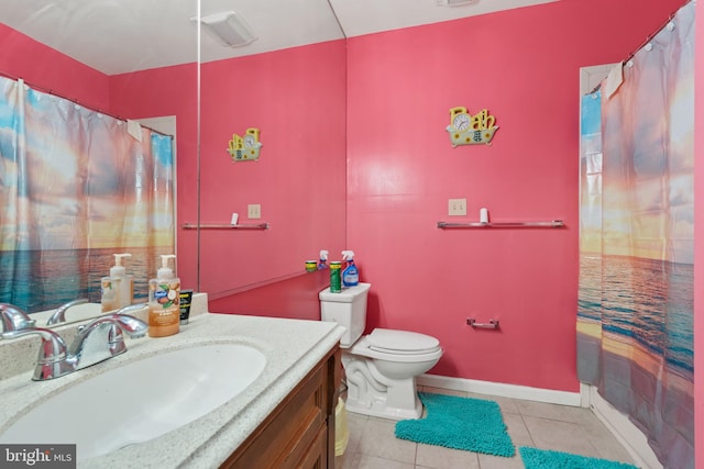 bathroom featuring toilet, vanity, tile patterned flooring, and a shower with curtain