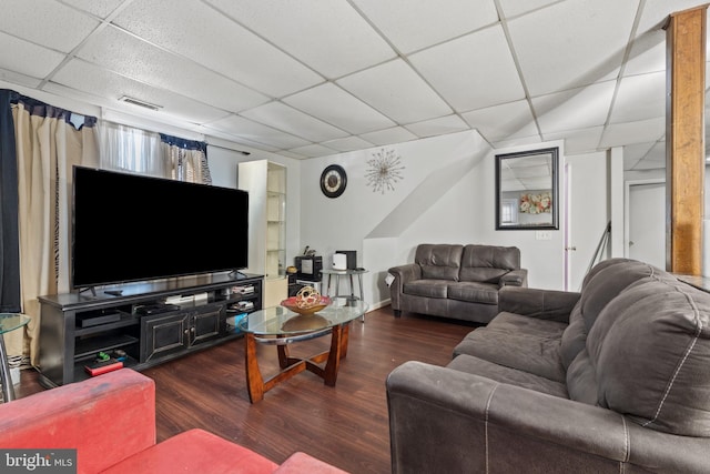 living room featuring a drop ceiling and dark hardwood / wood-style floors