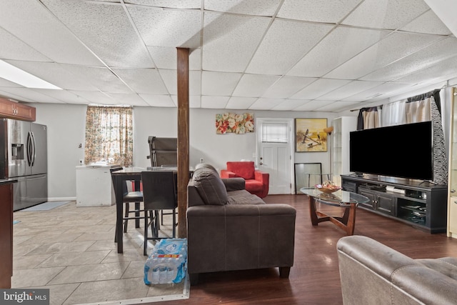 living room with a drop ceiling