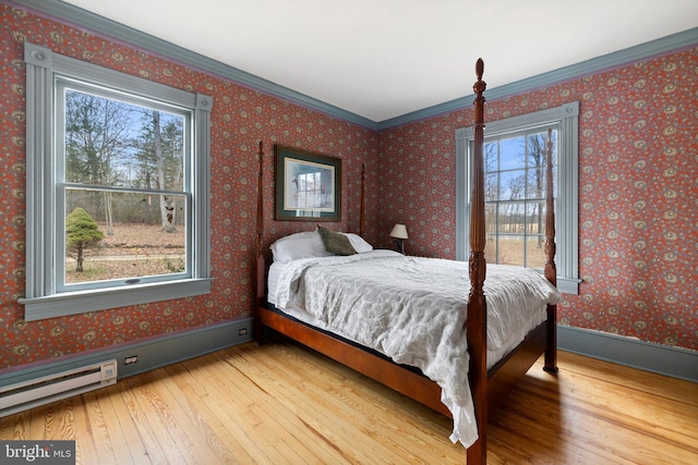 bedroom with crown molding and hardwood / wood-style flooring