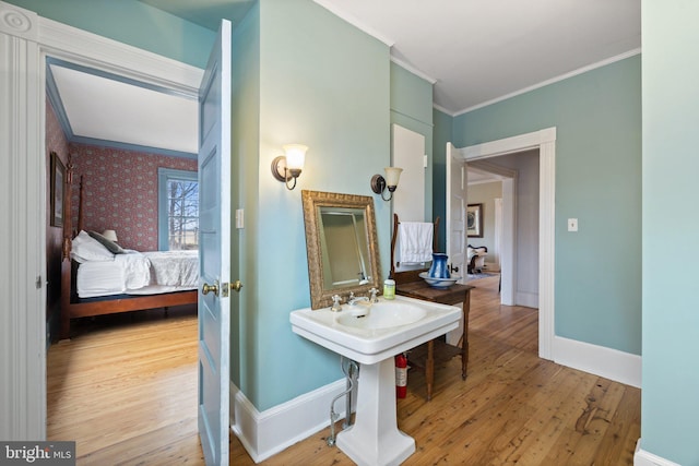 bathroom with crown molding and hardwood / wood-style flooring