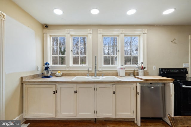 kitchen featuring white cabinetry, stainless steel dishwasher, black electric range, and sink