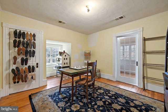 home office featuring crown molding and wood-type flooring