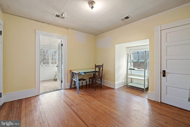 dining area featuring crown molding and hardwood / wood-style floors