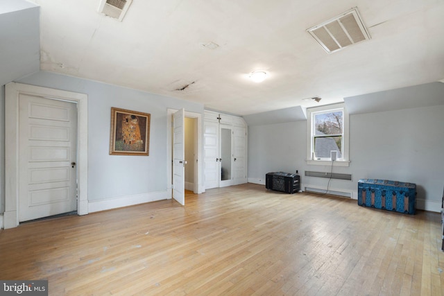 interior space with lofted ceiling and light wood-type flooring