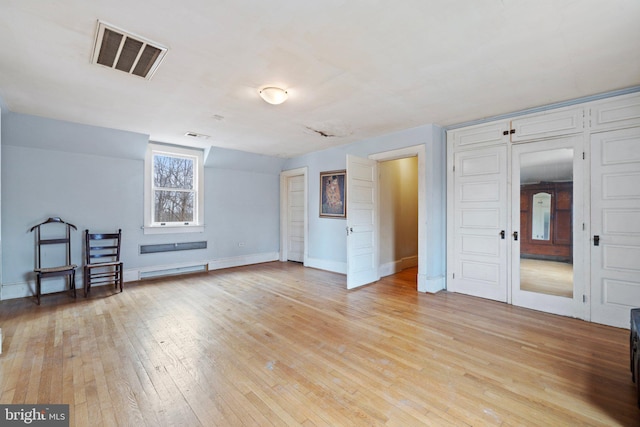 interior space featuring light hardwood / wood-style floors and baseboard heating