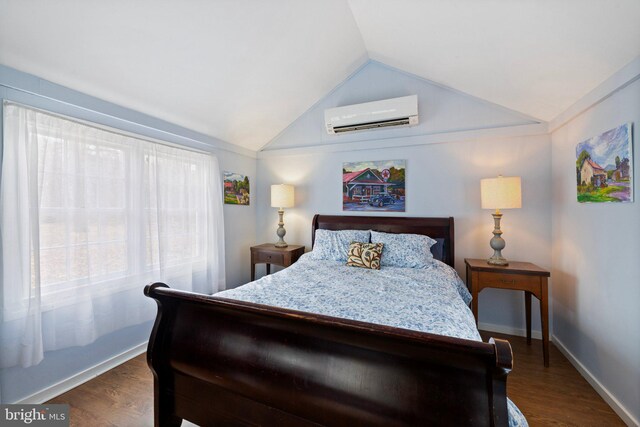 bedroom with an AC wall unit, dark wood-type flooring, and lofted ceiling