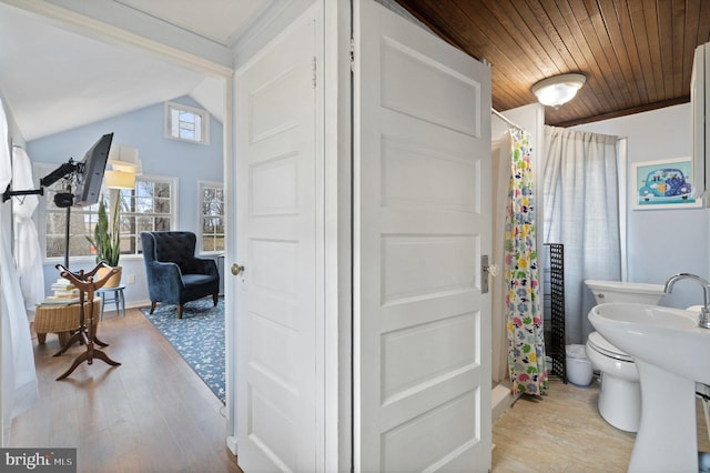 bathroom featuring vaulted ceiling, hardwood / wood-style flooring, wood ceiling, toilet, and a shower with shower curtain