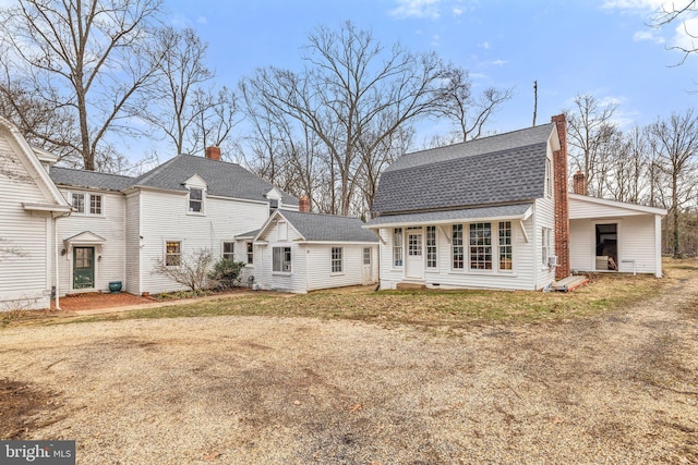 back of house featuring a lawn