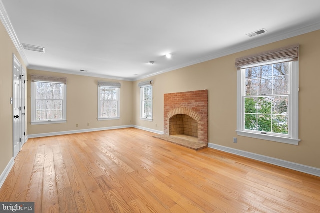 unfurnished living room featuring crown molding, light hardwood / wood-style flooring, and a fireplace