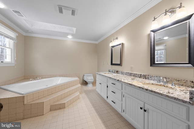 bathroom with tile patterned floors, vanity, a skylight, toilet, and ornamental molding